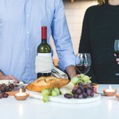 man standing beside woman holding wine glass in front of