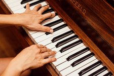 close up photo of person playing piano