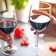 close up photo of two people toasting with red wine