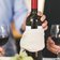 man holding white labeled red wine bottle near wine glasses