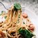 selective focus photography of pasta with tomato and basil