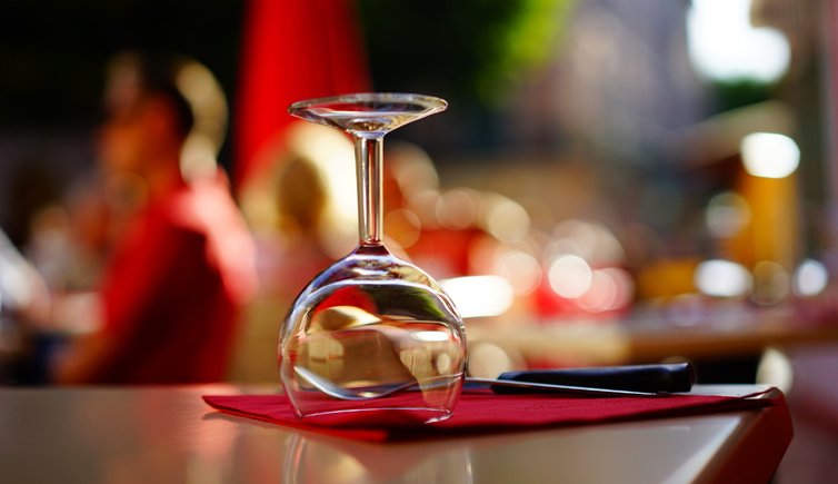 clear wine glass on top of brown table