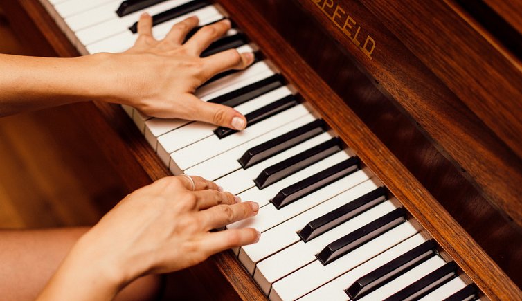 close up photo of person playing piano